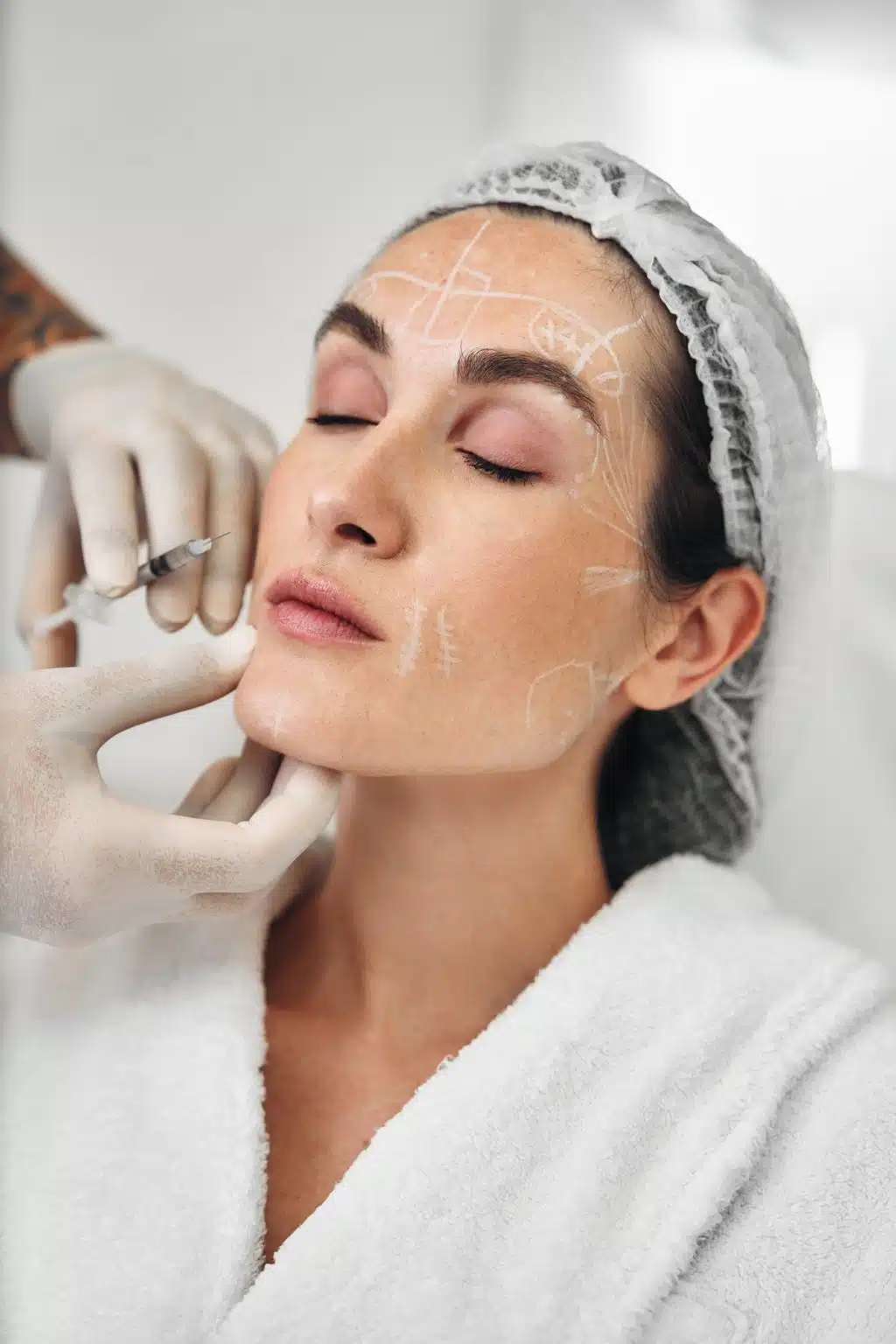 Woman receiving skin treatment in a spa during daylight hours